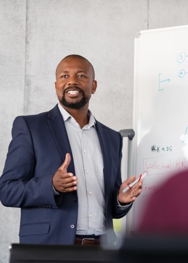 Mature african businessman training employees